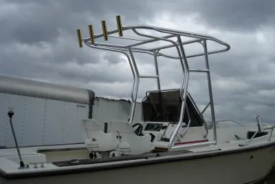 A center console boat with a finished aluminum T-top and rod holders